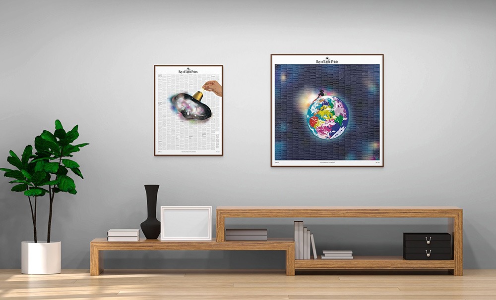 Two framed educational art prints — The Evolution of the Universe and The Elements of the World — displayed on a modern wall.