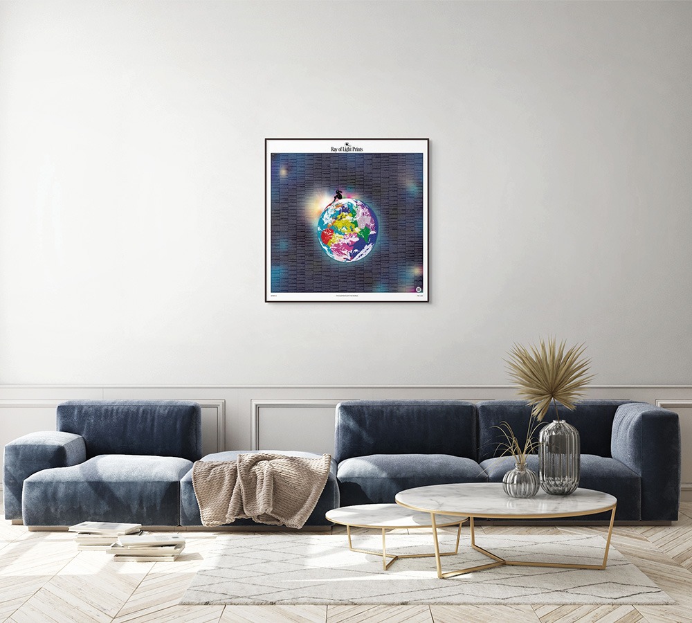 Living room with blue seating and framed Elements of the World print by Ray of Light Prints displayed on a pale wall.