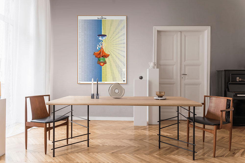 Minimal dining room interior with the Human Body Systems print by Ray of Light Prints displayed above a wooden table.