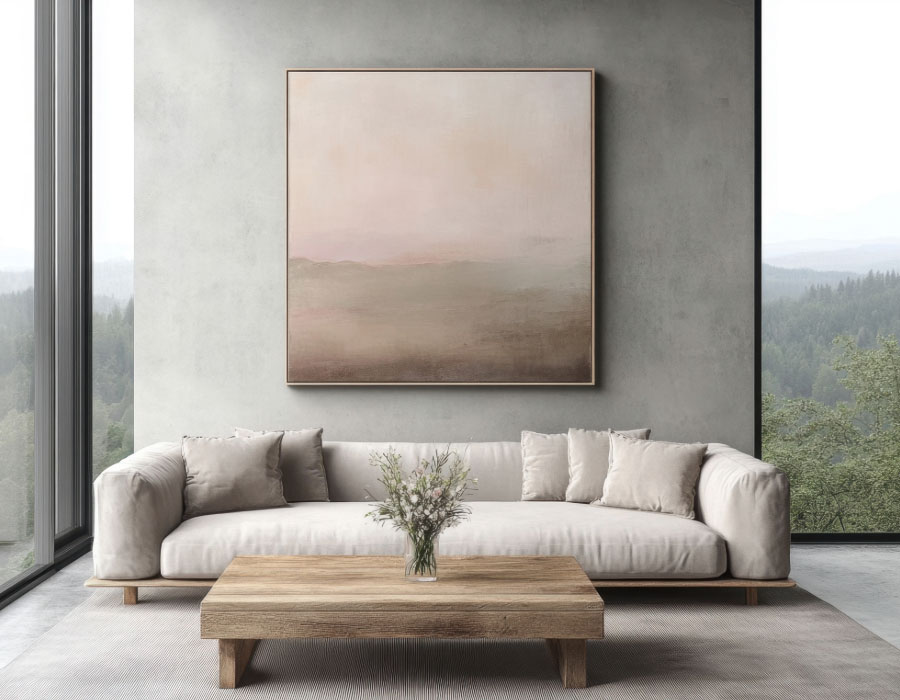Minimal living room with cream sofa, wooden coffee table and large soft-toned abstract painting on a concrete wall.